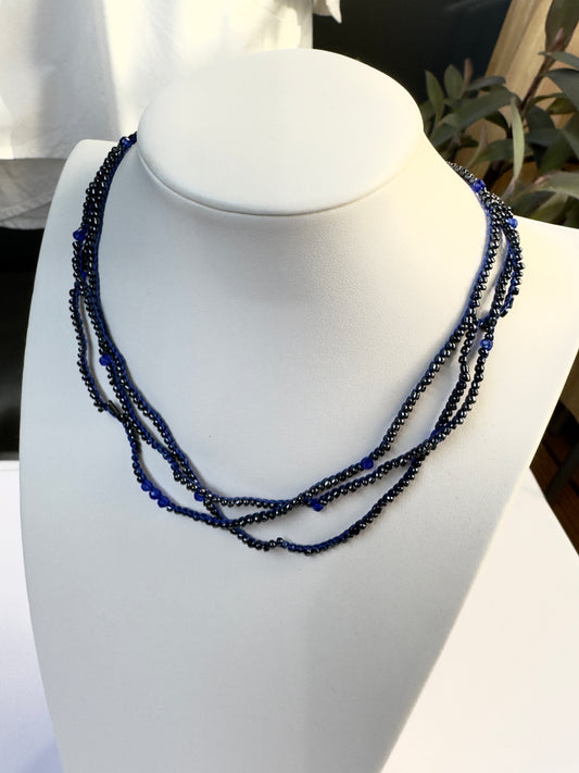 Crocheted necklace made from black beads and blue spinel